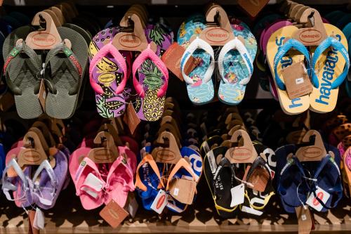 a bunch of shoes on display in a store at Sleepover Terminal 3, Concourse B - formerly sleep 'n fly in Dubai