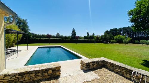 a swimming pool in the middle of a yard at Charming Farmhouse in Provence in Cavaillon