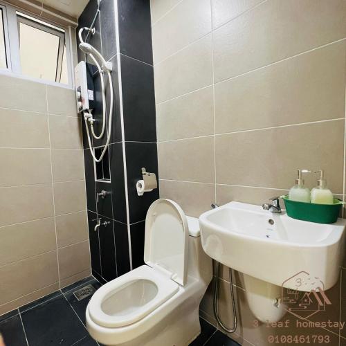 a bathroom with a toilet and a sink at KULAI IOI MALL D'Putra Suites Near JPO Senai Airport in Kampong Saleng