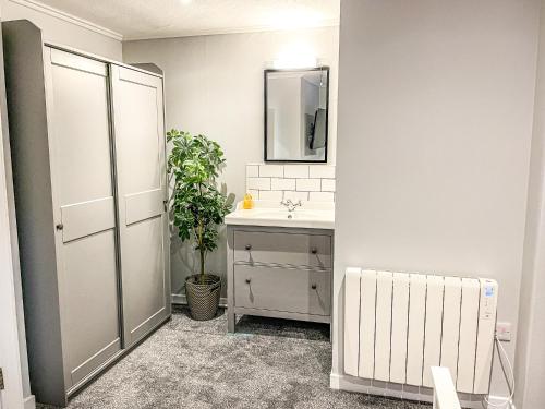 a bathroom with a sink and a mirror at Broadford House Skye in Broadford