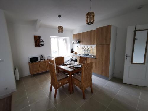 a kitchen with a table and chairs in a room at Le Nica in Trélazé