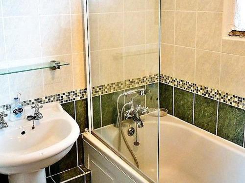 a bathroom with a sink and a toilet and a tub and a sinkktop at Mill Cottage in Fowey