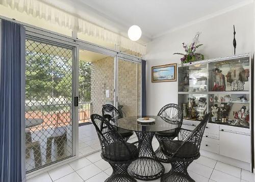 a dining room with a table and chairs at Solitaire 1 in Sawtell