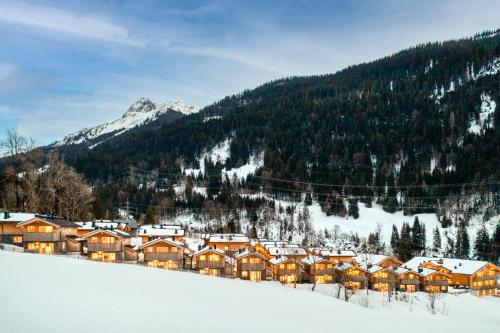 a town in the snow with a mountain in the background at Arlberg Chalets in Wald am Arlberg