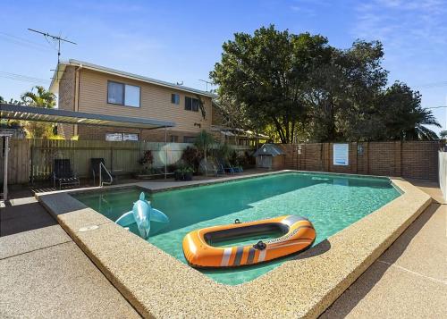 a small swimming pool with an orange boat in it at Driftwood Court 1 in Sawtell