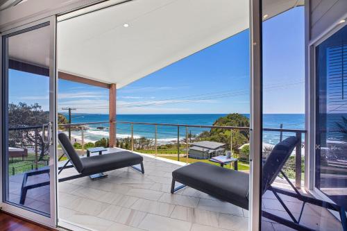 a house with a balcony with a view of the ocean at Gagaal Lookout in Scotts Head