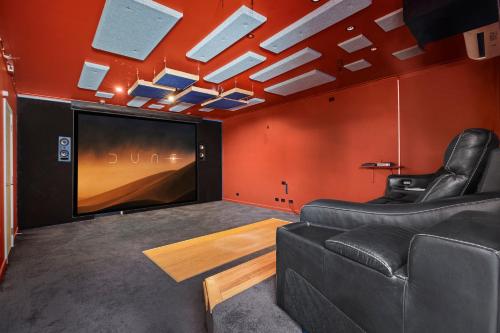 a room with a couch and a large screen tv at Gagaal Lookout in Scotts Head