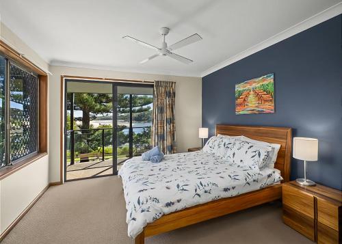 a bedroom with a bed and a window at Peninsula in Sawtell
