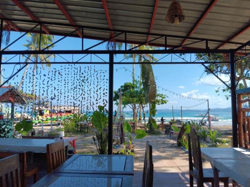 a restaurant with tables and a view of the beach at Casa Leonora in Sabang