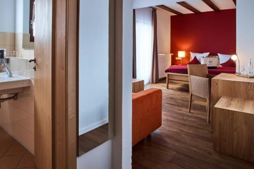 a hotel room with a bathroom and a bedroom at Berghotel Lothar-Mai-Haus in Hofbieber