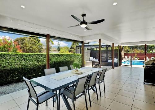 a dining room with a table and chairs at McCabe Coffs Retreat in Coffs Harbour