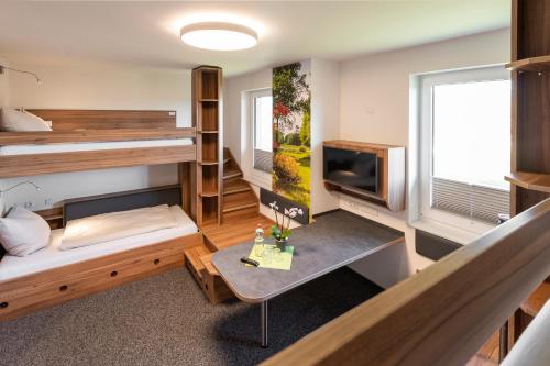 a room with bunk beds and a table at Hössensportzentrum in Westerstede