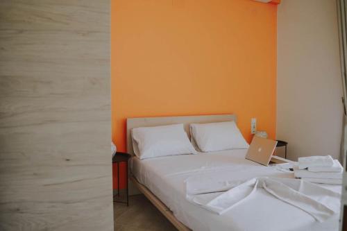 a bedroom with a bed with a laptop on it at Blue in Green South in Kastrosikia