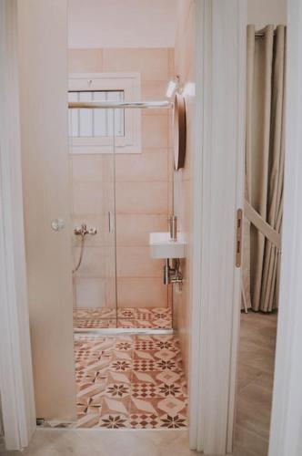 a bathroom with a shower and a sink at Blue in Green South in Kastrosikia