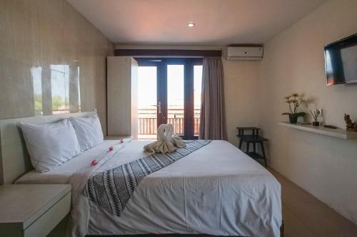 Ένα ή περισσότερα κρεβάτια σε δωμάτιο στο Pudi Homestay