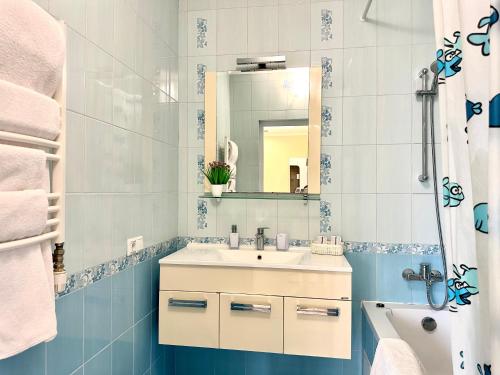a bathroom with a sink and a mirror at Lux apartments in the city center, near the park and Zlata Plaza in Rivne
