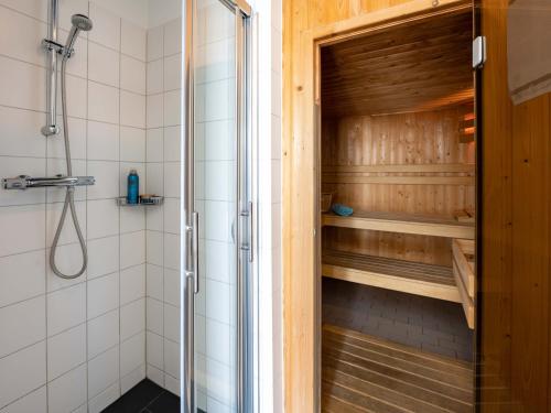 a shower with a glass door in a bathroom at Antibes 234 - Kustpark Village Scaldia in Hoofdplaat