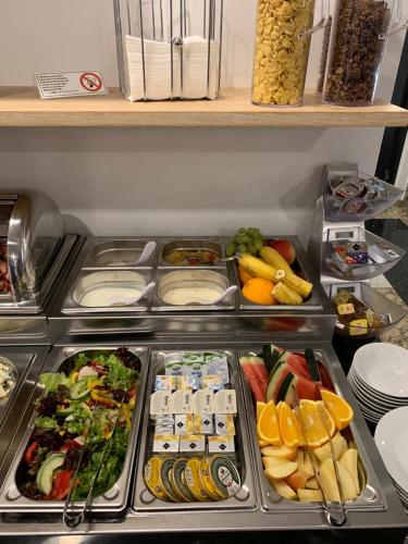 a refrigerator filled with lots of different types of food at Hotel Valcha in Prague
