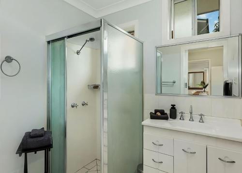 a bathroom with a glass shower and a sink at Nonna and Pops in Mylestom