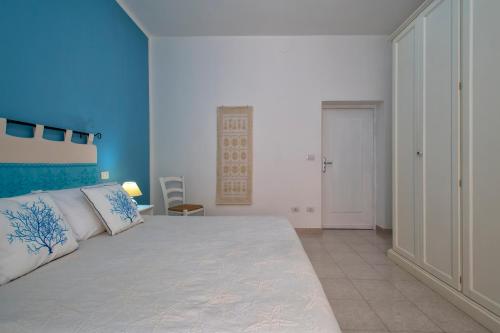 a bedroom with a large bed with a blue wall at Casa Vacanze San Michele in Alghero