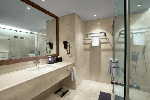 a bathroom with a sink and a shower at ASTON Priority Simatupang Hotel and Conference Center in Jakarta