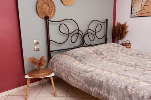 a bedroom with a bed and a table with a basket at Boho House Florina in Florina