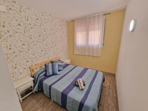 a bedroom with a bed with a towel on it at Apartamento Gran Reserva Beach-3 in Empuriabrava