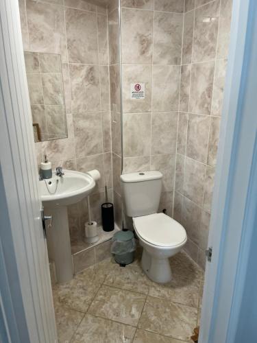 a bathroom with a toilet and a sink at St Georges Guest House in St Peter Port