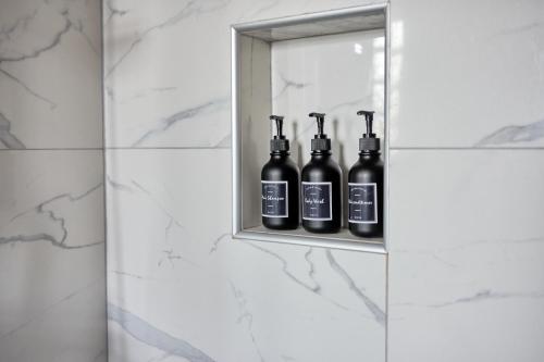 a shelf with four bottles of wine in a bathroom at Florina Sky Loft in Florina