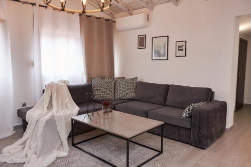 a living room with a couch and a coffee table at Florina Sky Loft in Florina