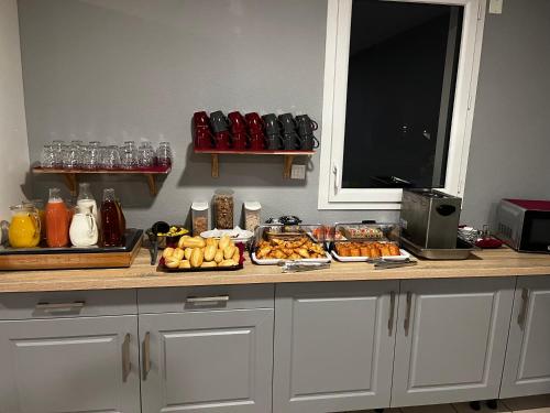 a counter with many different types of food on it at Zenao Appart'Hotel in Nevers