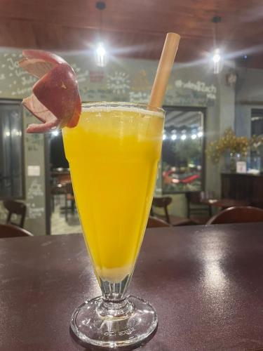 a glass of orange juice sitting on a table at Sapa Hills Hotel in Sa Pa