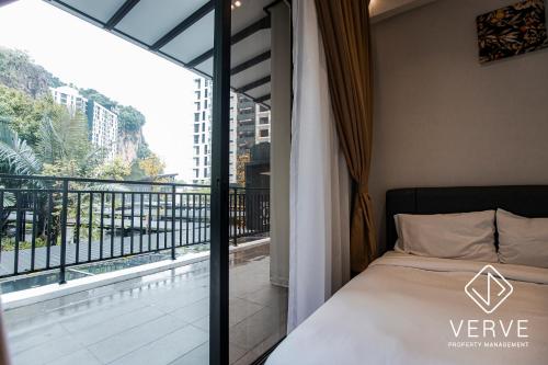 a bedroom with a balcony with a bed and a window at Ipoh Cove Premium Suites by Verve in Ipoh