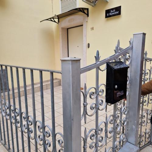a metal fence with a mailbox on it at B&B Il Rosone in Massafra