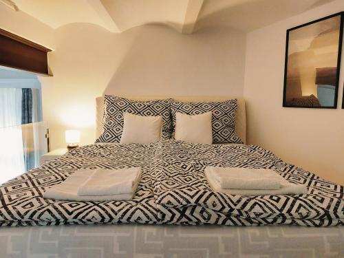 a bedroom with a large bed with two pillows at SQUARE 16 - Absolutely Central Location in Szombathely