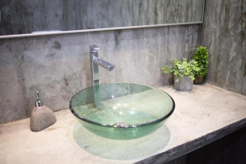 a bathroom sink with a glass bowl on a counter at Casa Le Rock in Kuah