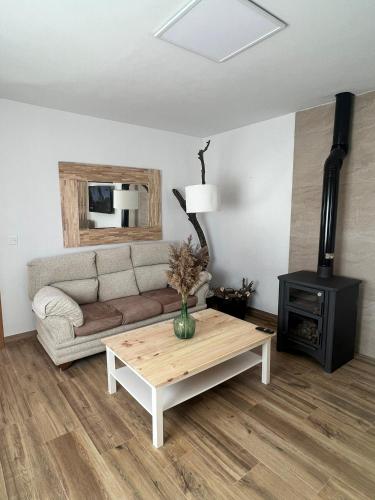 a living room with a couch and a coffee table at Casa Rural La Chicuela in Los Villares