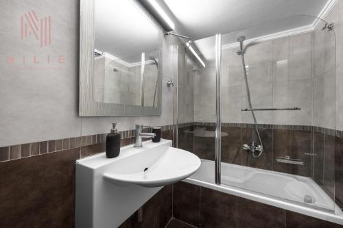 a bathroom with a sink and a shower at Green Tulip, Nilie Hospitality MGMT in Thessaloniki