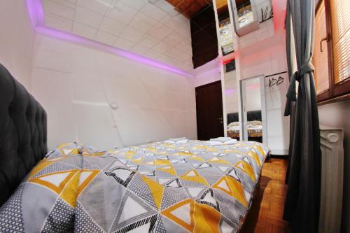 a bedroom with a bed with a colorful comforter at Hedonist Spa Jacuzzi Sarajevo Free parking in Sarajevo