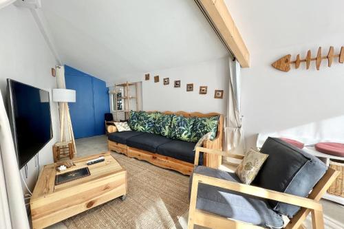 uma sala de estar com um sofá e uma televisão em Leon's house in Saint Aygulf em Fréjus