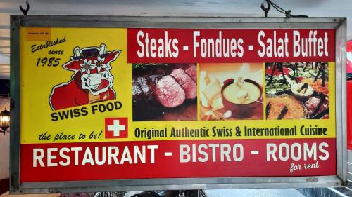 a sign for a restaurant with food on it at Swiss Food Restaurant and room for rent in Pattaya South