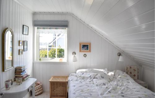 a white bedroom with a bed and a window at Cozy Home In Bakkasund With Kitchen in Bakkasund