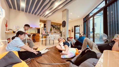 un grupo de personas sentadas en el suelo en una sala de estar en 嵐文人旅店, en Chishang