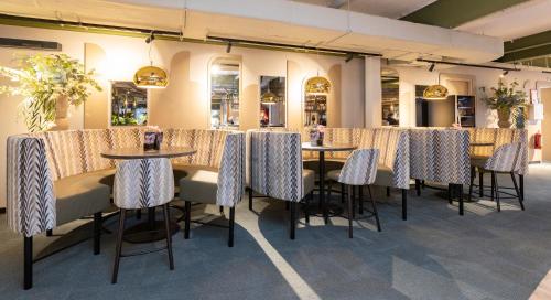 a row of tables and chairs in a room at Fletcher Hotel-Restaurant Marknesse in Marknesse