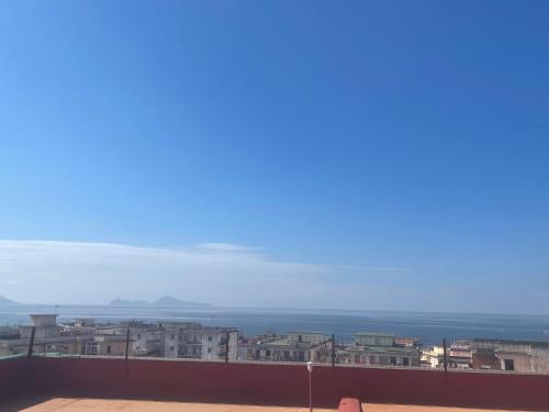 a view of a city with buildings and the ocean at Terrazza Belvedere in Ercolano