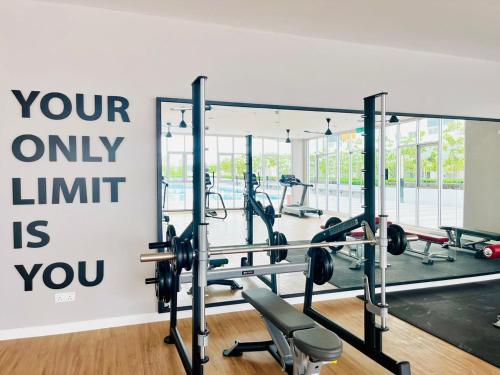a gym with tread machines and a sign that reads your only limit is you at Alanis Suite With Netflix @ KLIA Sepang in Sepang