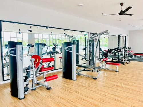 a gym with several tread machines in a room at Alanis Suite With Netflix @ KLIA Sepang in Sepang