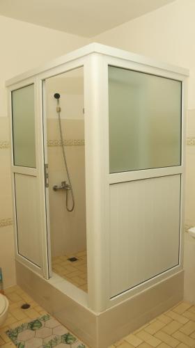 a shower with a glass door in a bathroom at HÔTEL TAJ in Antananarivo