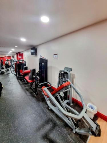a gym with a row of treadmills and machines at Muthu Belstead Brook Hotel in Ipswich