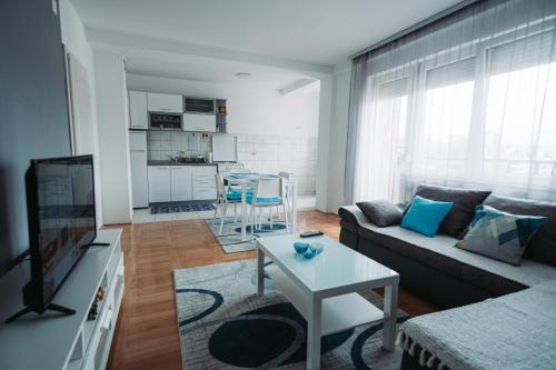a living room with a couch and a table at ASPERA Apartments in Kumanovo